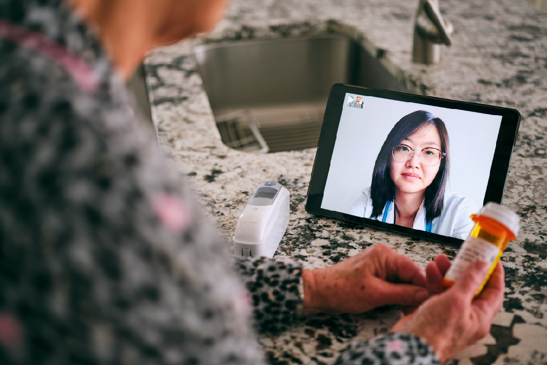 Patient speaking to healthcare worker on tablet