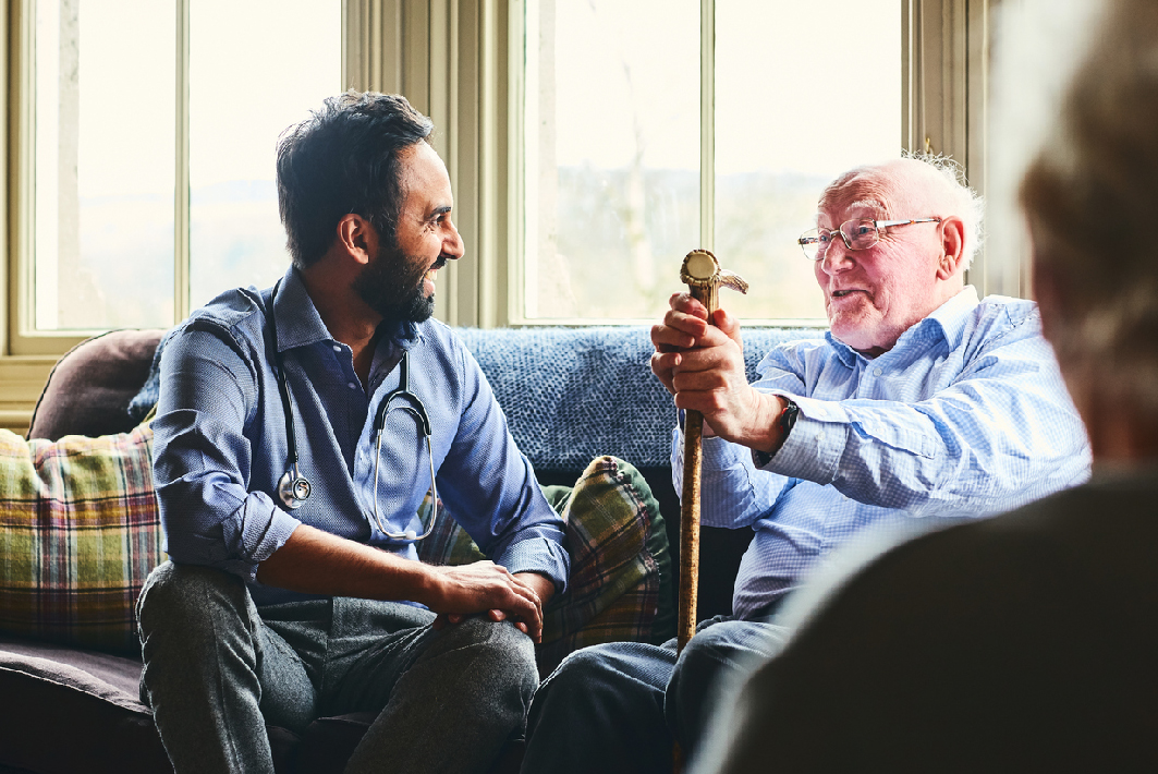 Healthcare worker speaking with an older adult at home