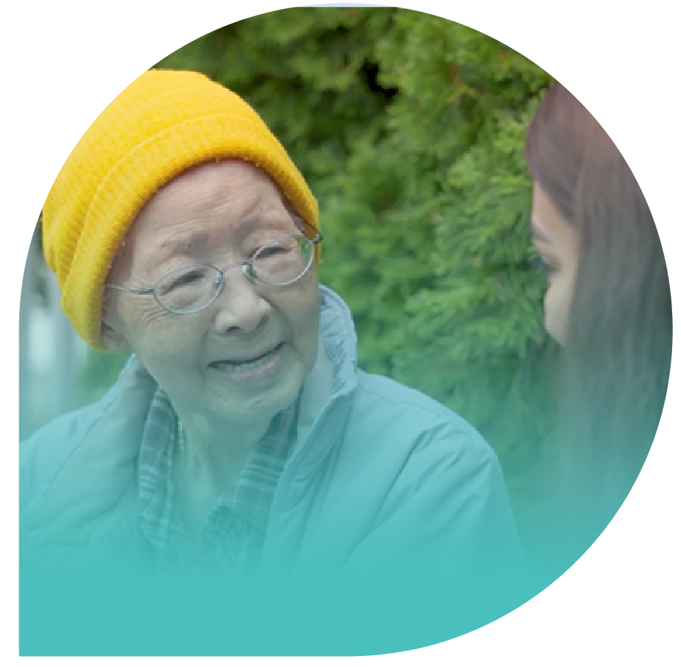 Older adult smiling at caretaker.