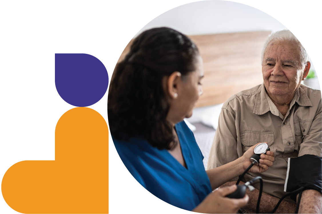 A healthcare provider checks a patient’s blood pressure at their home.