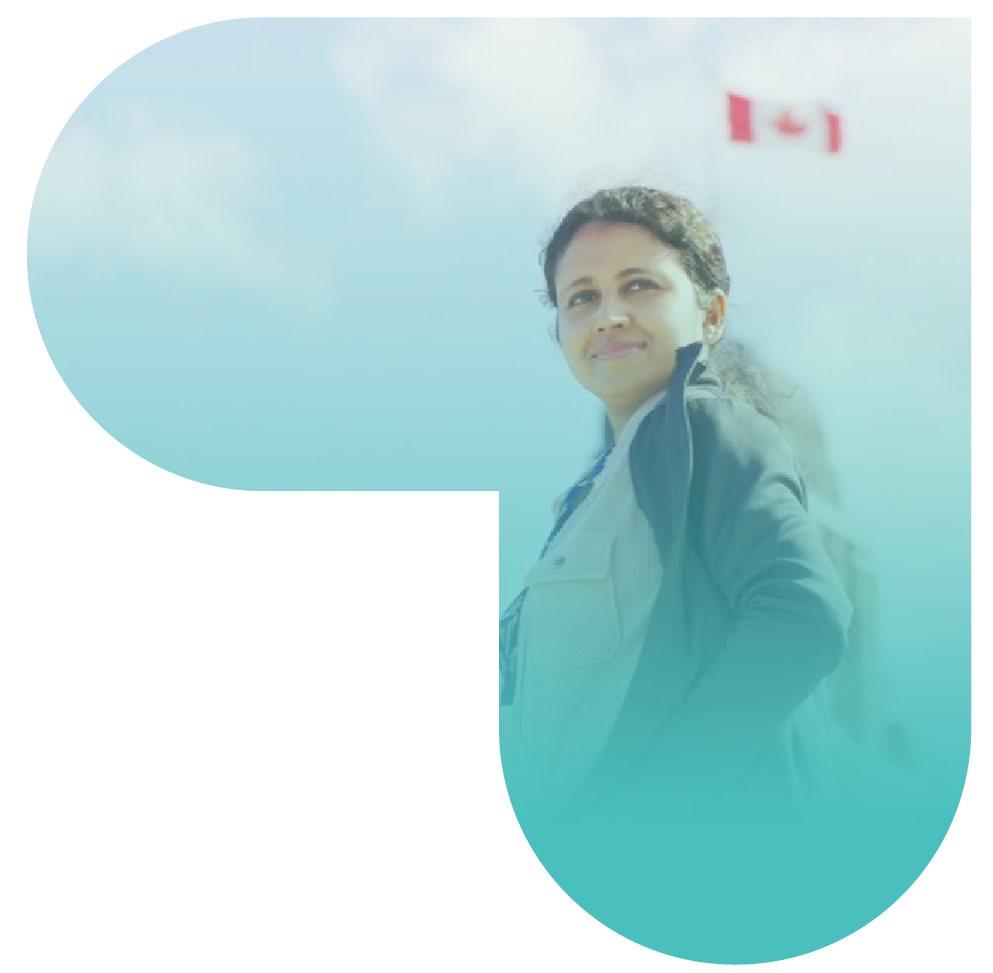 Nurse smiling and looking off into the distance with the Canadian flag on a pole in the background.