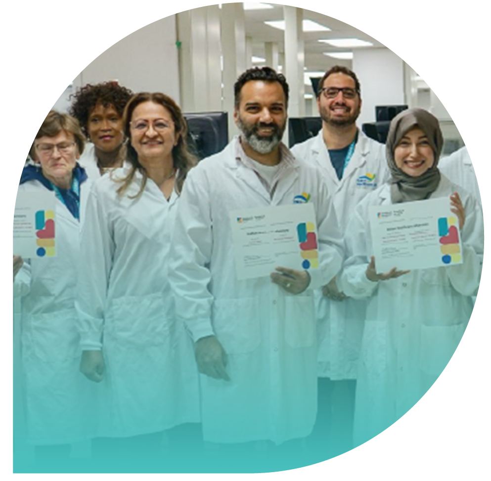 Individuals wearing white lab coats, posing for a group photo and holding certificates with the HEC logo.